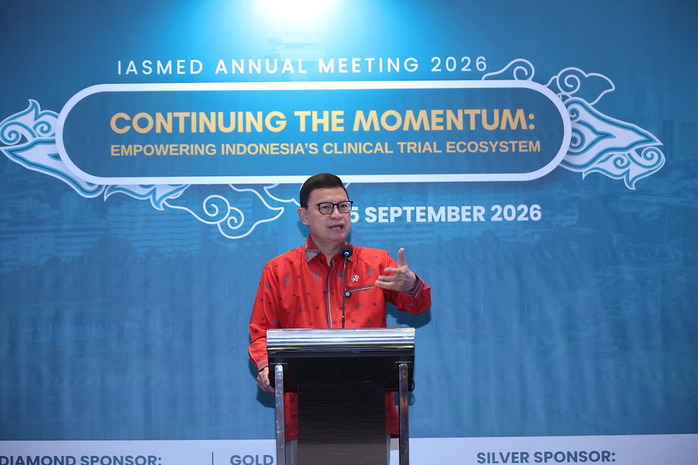 Chairperson of BPOM in red shirt speaks at a podium before an IASMED Annual Meeting 2026 backdrop about Indonesia’s clinical trial ecosystem.
